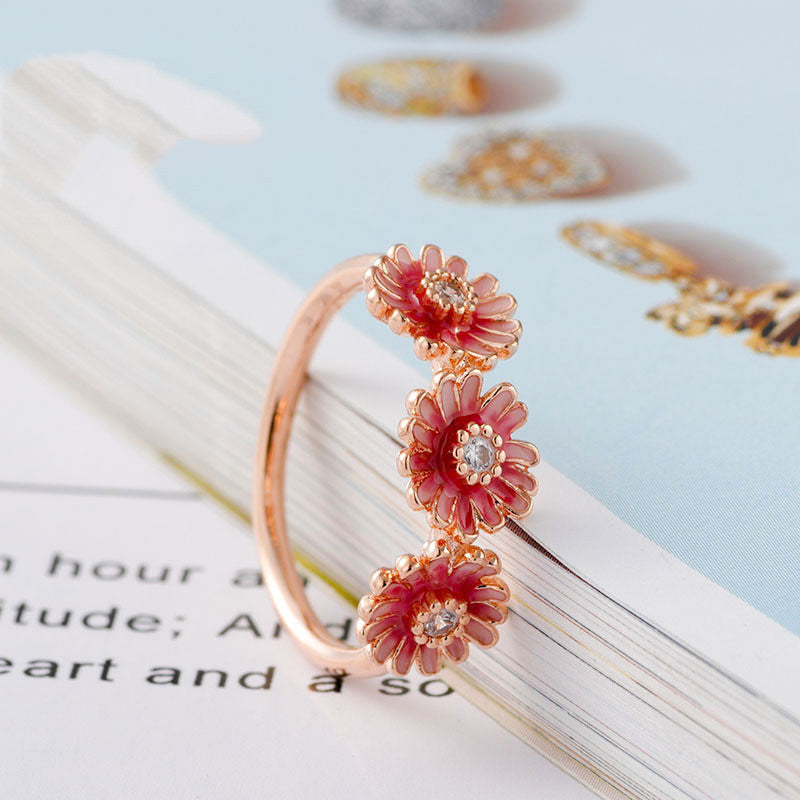 Three pink daisy rings